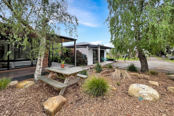 Discover a unique outdoor space featuring a picnic area surrounded by natural landscaping and modern amenities.