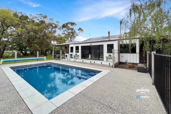 This spacious property features a large pool and versatile outdoor space, ideal for entertaining and relaxation.
