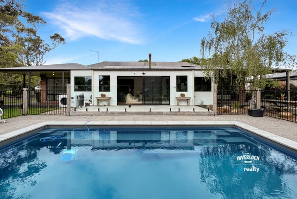Contemporary home featuring a spacious poolside area, ideal for outdoor entertaining and relaxation.