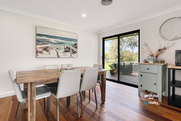 Bright dining area featuring large windows, showcasing views of the outdoors and modern design elements.
