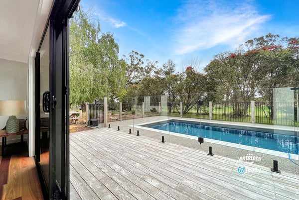 Spacious indoor-outdoor living with modern pool views, surrounded by lush greenery and serene landscapes.