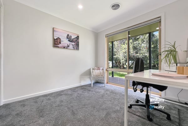 Bright and spacious room with large windows, offering peaceful views and ample natural light for productivity.