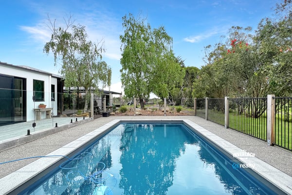 This property features a refreshing pool and landscaped yard, perfect for outdoor gatherings and relaxation.