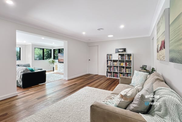 Spacious living area with modern finishes, large windows, and an inviting atmosphere perfect for relaxation.