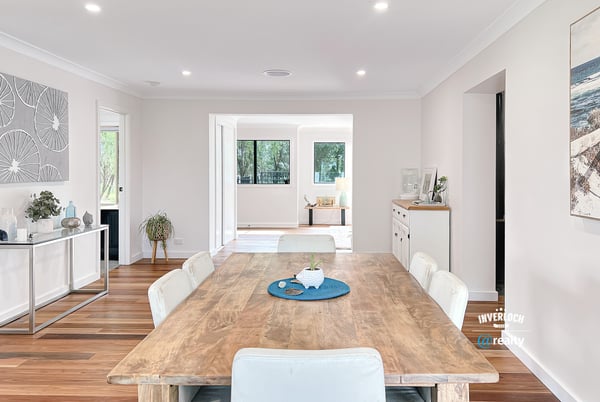 Spacious open-concept living area featuring a modern dining space and abundant natural light throughout.