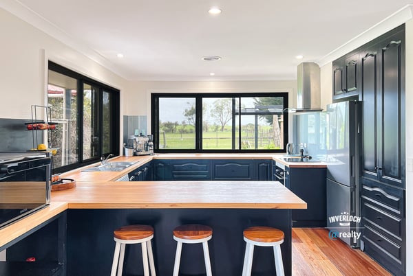 Modern kitchen featuring sleek cabinetry, expansive windows with scenic views, and a spacious island for entertaining.