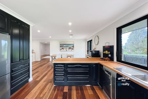 Modern kitchen featuring rich wood accents, ample counter space, and an open layout perfect for entertaining.
