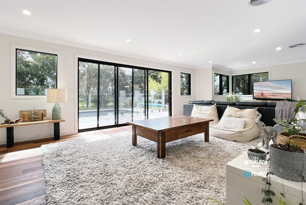 Spacious living area featuring large windows, modern furnishings, and seamless indoor-outdoor flow for relaxation and entertainment.