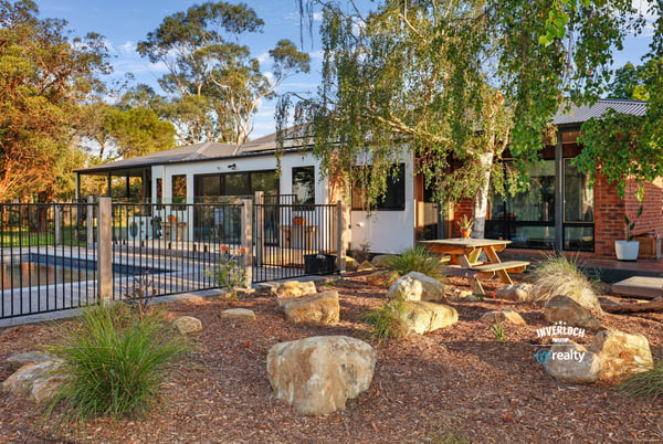 This inviting home features a spacious outdoor area with landscaped gardens and a relaxing poolside retreat.