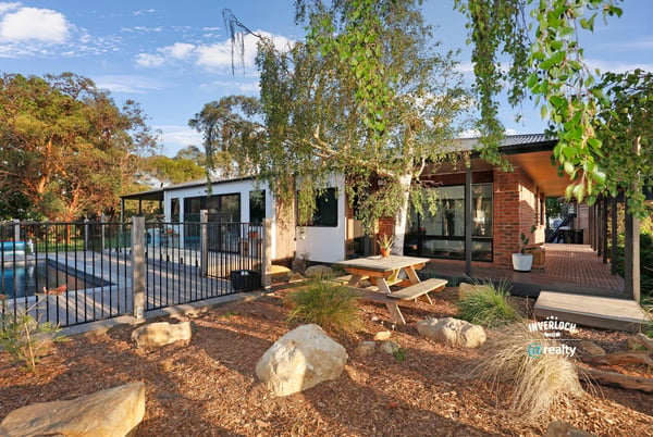 Discover this modern home featuring an inviting outdoor space, pool, and beautiful landscaping for relaxed living.