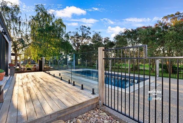 Discover a modern outdoor retreat featuring a pristine pool and expansive nature views, perfect for relaxation.