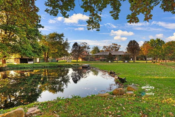Discover a picturesque waterfront property surrounded by lush greenery and ample outdoor space for relaxation.