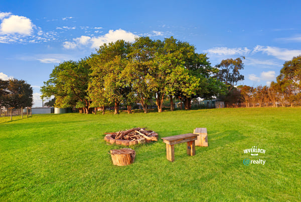 Expansive outdoor space featuring a cozy fire pit area, perfect for gatherings and relaxation.