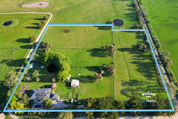 Expansive property featuring lush pastures and water features, perfect for agricultural pursuits or private retreat.