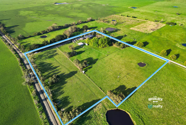 Spacious rural property featuring open fields, ponds, and mature trees, offering endless possibilities for development.