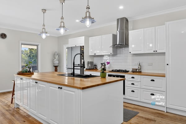 Discover this modern kitchen featuring a spacious island, sleek appliances, and abundant natural light.
