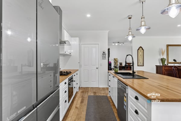 Modern kitchen featuring sleek appliances, abundant counter space, and a functional layout perfect for culinary enthusiasts.
