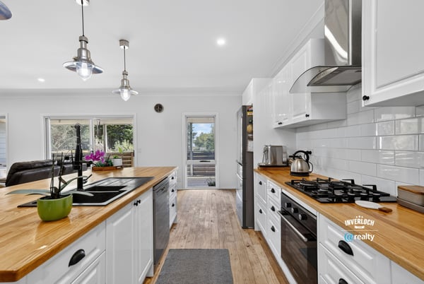 Bright kitchen with wooden countertops, modern appliances, and ample natural light, perfect for culinary enthusiasts.