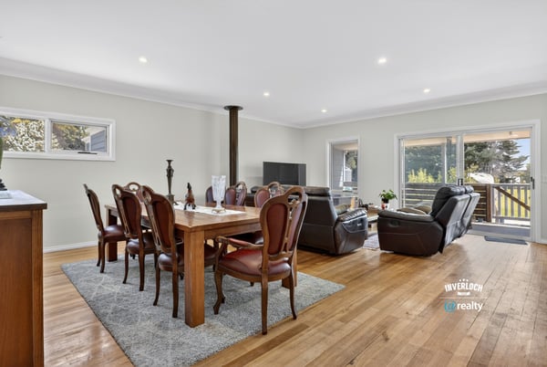 Spacious open-concept living and dining area with abundant natural light and direct access to the patio.