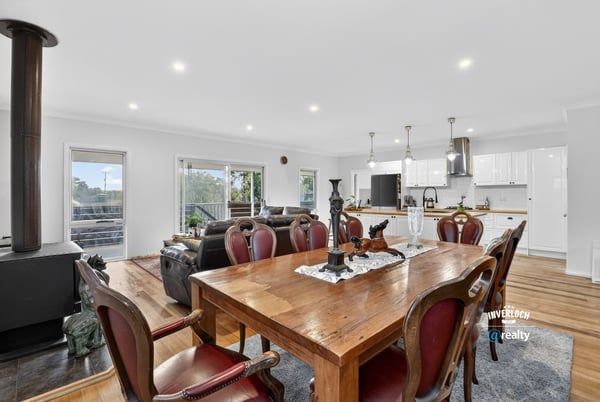 Spacious open-plan living and dining area with modern furnishings and ample natural light throughout.