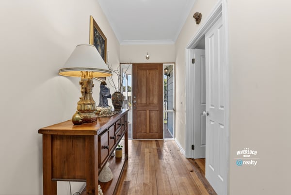 Bright and inviting entryway featuring warm hardwood floors and a view of the welcoming front door.