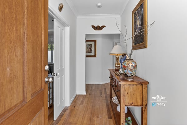 Welcoming entryway featuring warm wooden accents, unique decor, and a cozy atmosphere for guests.
