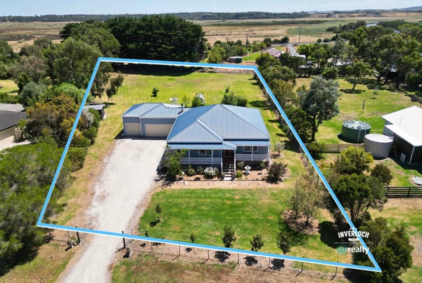 Spacious property featuring a large yard, dual garage, and expansive views in a tranquil rural setting.