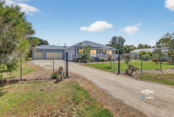 Spacious property with a welcoming entrance, featuring ample parking and beautifully landscaped grounds.