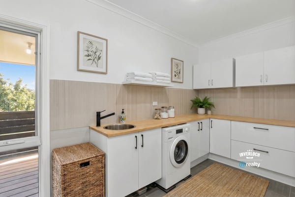 Bright and functional laundry space featuring modern appliances and ample storage for a streamlined experience.