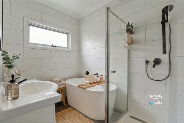 Modern bathroom featuring a sleek freestanding tub, spacious walk-in shower, and contemporary fixtures for a refreshing experience.
