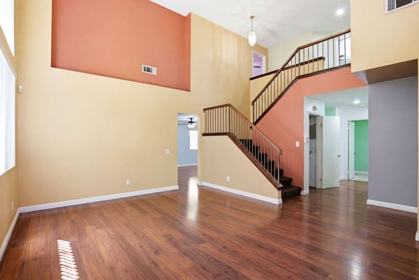 Spacious open layout featuring vibrant accent walls and natural light, perfect for modern living and entertaining.