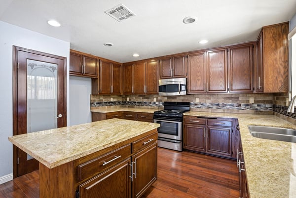Spacious kitchen featuring rich wood cabinetry, modern appliances, and ample counter space for cooking and entertaining.