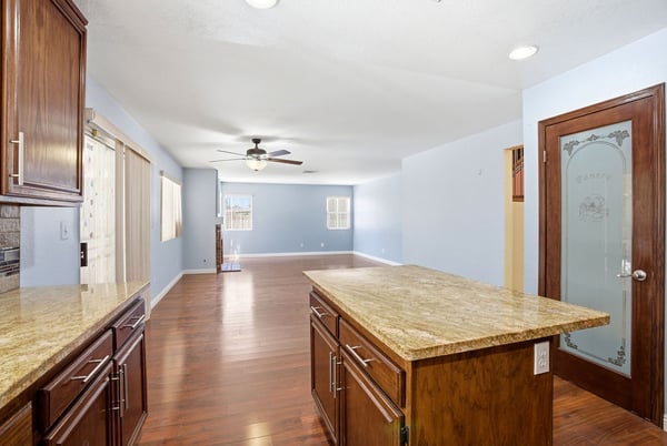 Spacious open-concept living area with a modern kitchen island and abundant natural light.