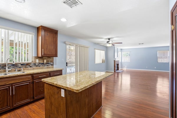 Spacious open-concept living area with modern finishes, offering seamless flow between kitchen and family room.