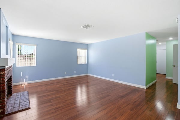 Bright, open living space featuring fresh paint and hardwood floors, ideal for your personal touch.