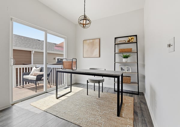 Bright and inviting space flexible for dining or working featuring large windows and a seamless indoor-outdoor flow to the deck.