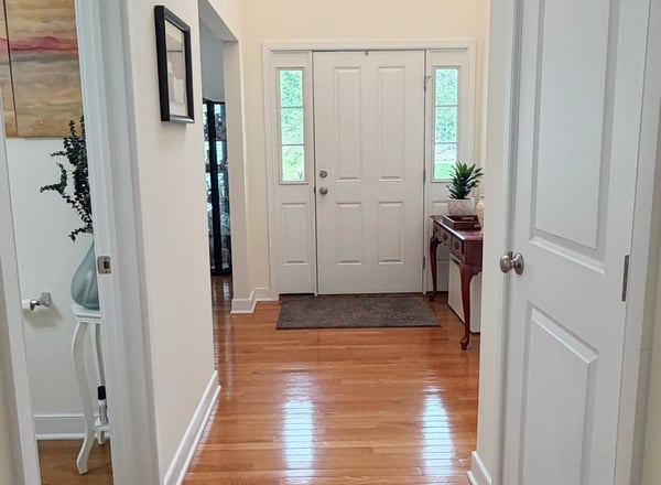 Front Hallway w/ Half Bath, Coat Closet, and Stairway to Bsmt