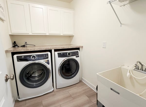 2nd Fl Laundry Rm w/ Utility Sink & Built-in Shelf & Cabinets. Electrolux W/D Included