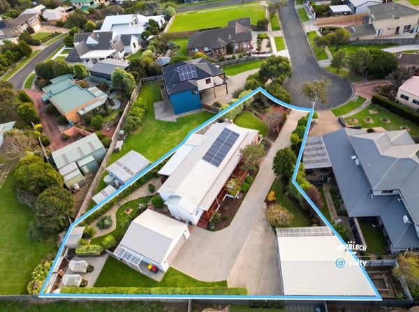 Spacious property featuring a large outdoor area and solar panels, nestled in a modern neighborhood.
