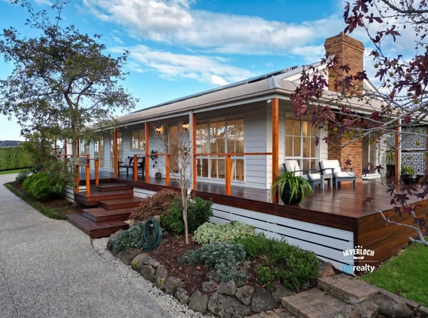 Inviting home features a spacious deck, landscaped garden, and picturesque setting, perfect for outdoor living.