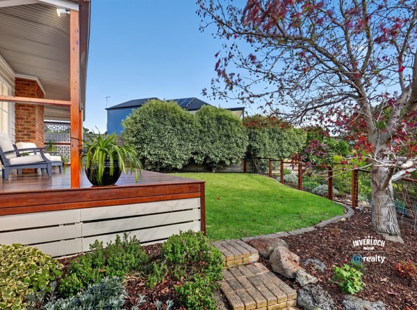 Inviting outdoor space with landscaped garden and seating area, perfect for relaxation and entertaining.