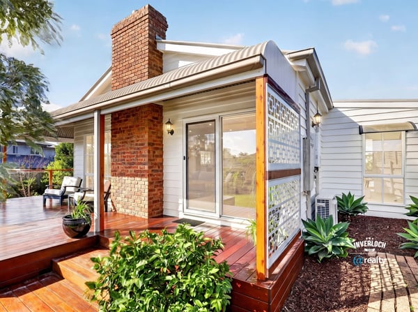 Inviting home features a spacious deck and lush landscaping, perfect for outdoor gatherings and relaxation.