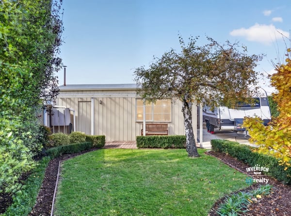 This modern property features a landscaped garden and inviting outdoor space perfect for relaxation and entertainment.