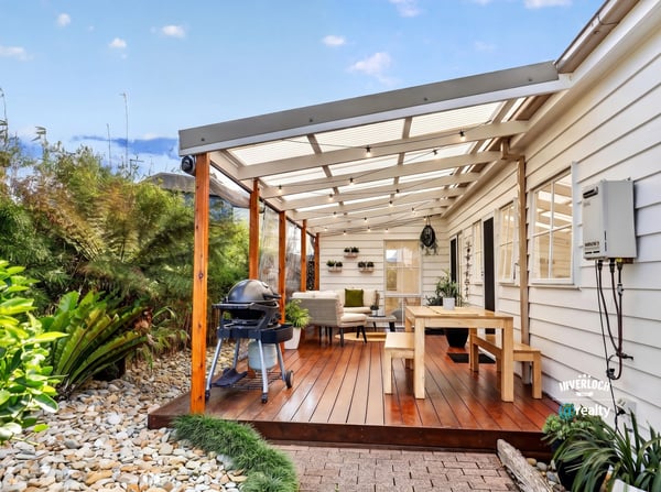 Spacious covered patio with ample seating and outdoor grilling area, perfect for entertaining and relaxing.