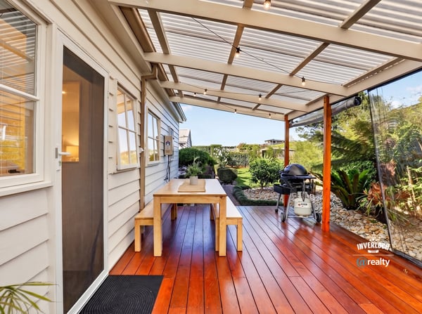 Enjoy outdoor living on this spacious deck, surrounded by lush greenery and perfect for entertaining.