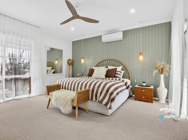 Bright and spacious bedroom featuring neutral tones, a comfortable bed, and inviting decor for relaxation.