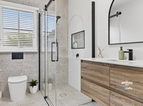 Modern bathroom featuring sleek lines, a spacious shower, and ample natural light for a refreshing ambiance.
