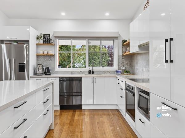 Modern kitchen featuring sleek cabinetry, stainless steel appliances, and abundant natural light for an inviting atmosphere.