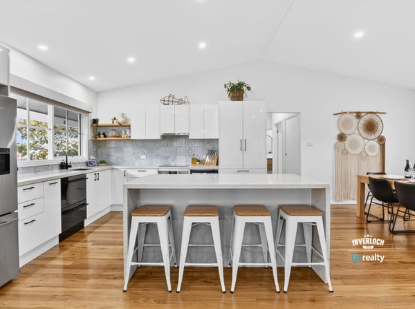 Bright, open kitchen with modern appliances, spacious island, and inviting dining area for entertaining.
