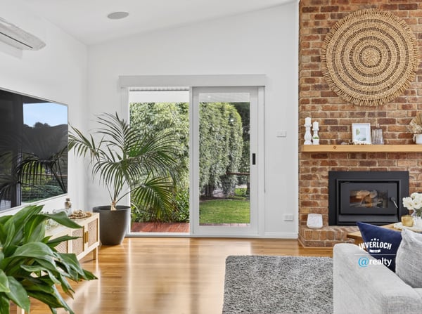 Bright living space featuring a cozy fireplace, modern amenities, and seamless indoor-outdoor access.